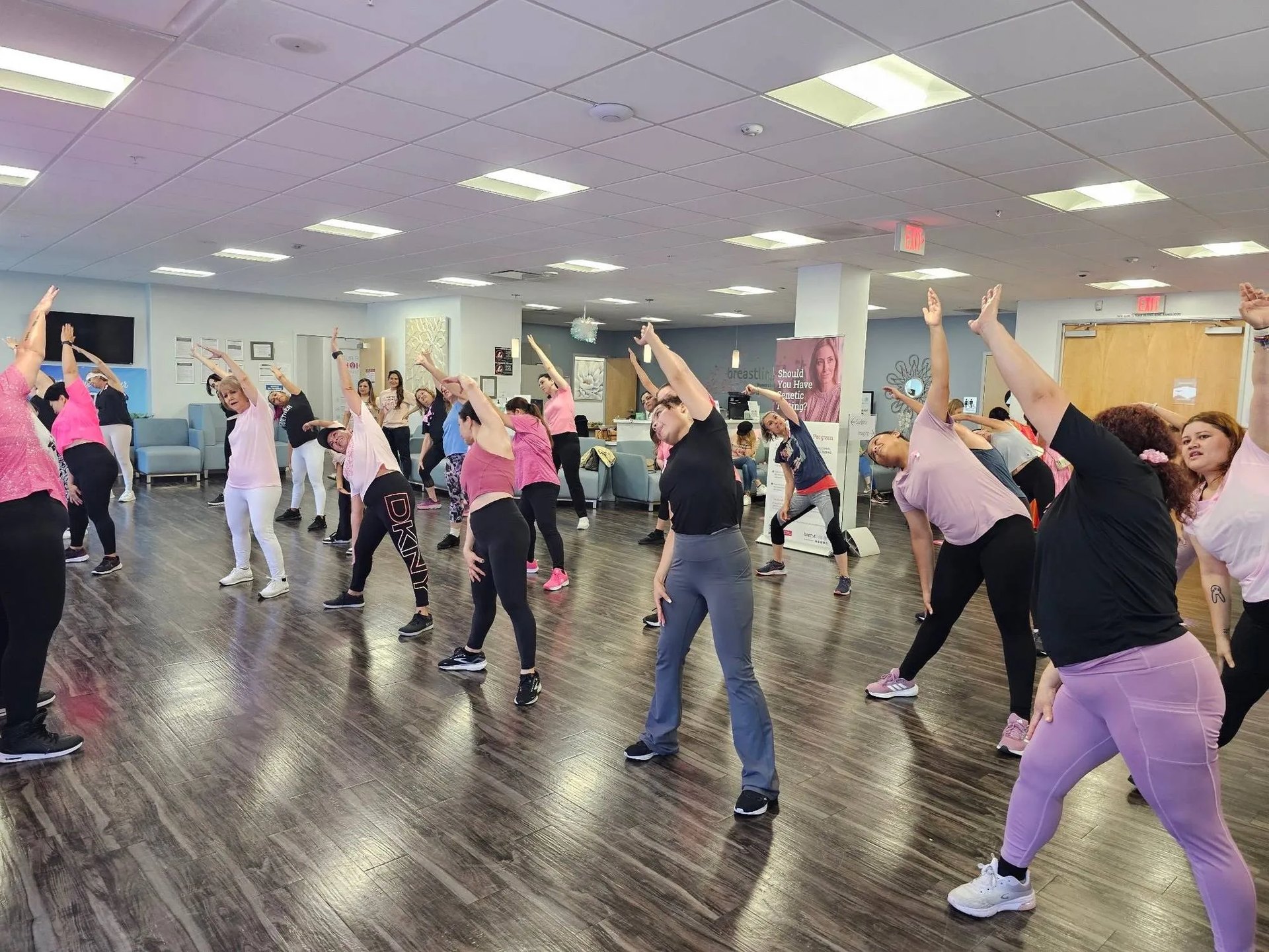 A full room of participants of all ages taking part in the cardio dance class